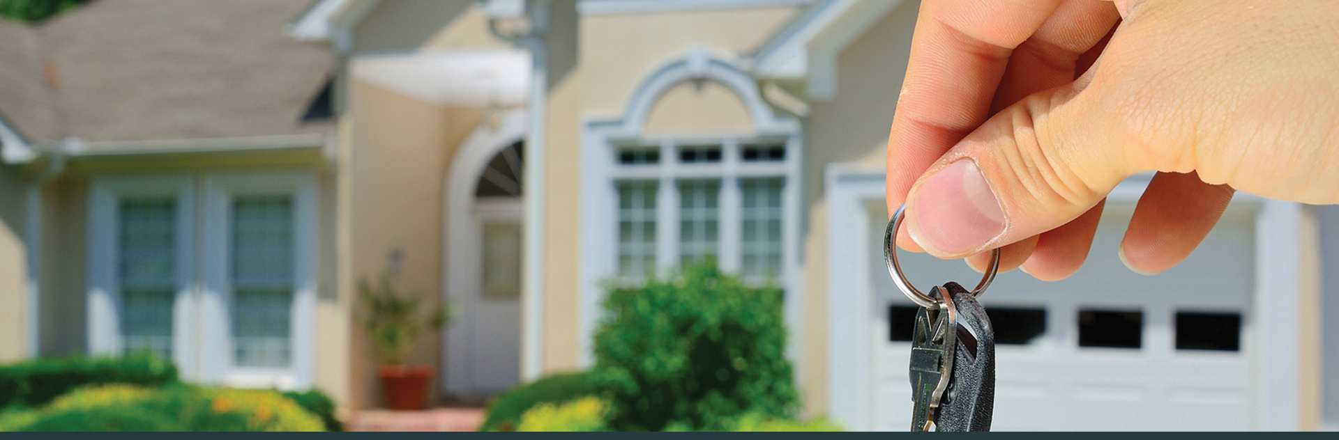 Close Up of Owner Holding Keys to House at Hillsboro Title Insurance